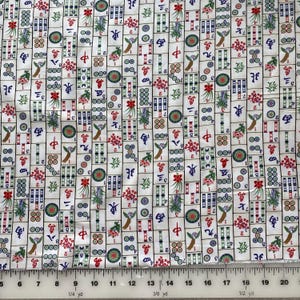 May include: White fabric with a repeating pattern of colorful Mahjong tiles. The tiles feature Chinese characters, numbers, and decorative elements in red, green, blue, and gold. The fabric is suitable for sewing and crafting projects.