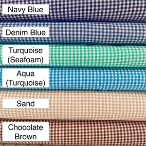 May include: Six rolls of gingham fabric in various colors, including navy blue, denim blue, turquoise, aqua, sand, and chocolate brown.