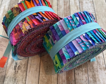 May include: Two bundles of colorful fabric strips, tightly rolled and secured with light blue ribbon. The fabric features a variety of vibrant colors and patterns, including floral and abstract designs. Ideal for quilting or other fabric crafts.