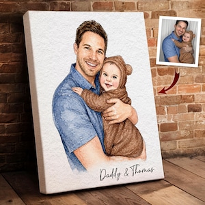 May include: Watercolor portrait on canvas of a father and child. The father, in a blue shirt, embraces the child in a brown bear costume. The canvas is signed "Daddy & Thomas". A smaller photo is in the upper right corner.