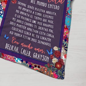 May include: Purple and floral patterned blanket with a Spanish language message that reads "DEL MUNDO ENTERO SIEMPRE SER&Aacute;S NJESTRA ABUELITA. NO IMPORTA A CONDE ESTEMOS NO IMPORTA EL TIEMPO QUE PASE. O LO MAYORES QUE NOS HAGAMOS NO DUDES CUANDO TE SIENTAS MAL. SOLO MANT&Eacute;N APRETADA ESTA COBIJA. COL&Oacute;CALO CERCA DE TU CORAZ&Oacute;N ASI NUNCA ESTAREMOS SEPARADOS. Con mucho amor, DELILAH, CALEB, GRAYSON"