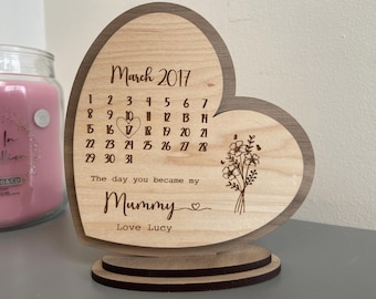 May include: A wooden heart-shaped calendar with the month of March 2017 displayed. The calendar is engraved with the text "The day you became my Mummy" and "Love Lucy".