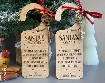 May include: Two wooden door hangers with the text "Santa's Magic Key" and a key attached with a red ribbon. The text on the sign reads "We have no chimney...to put some presents under the tree."