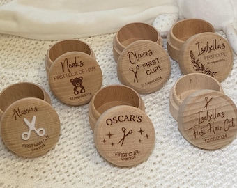 May include: Five wooden boxes with engraved lids. Each box has a different name and inscription, such as "Noah's First Lock of Hair" and "Isabella's First Curl".