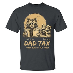 May include: Dark grey t-shirt with a graphic of two raccoons wearing sunglasses, holding a drink and fries. The text reads "DAD TAX" and "MAKING SURE IT'S NOT POISON". The names "William" and "Sophia" are also included.