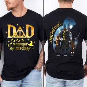 May include: Black t-shirt with gold text that reads "DAD manager of mischief" and a graphic of the Hogwarts crest. The back of the shirt features a silhouette of a wizard with two children, with the text "Best Dad Ever" and the names "James, Daddy, Emma".
