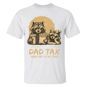 May include: White t-shirt with a graphic of two raccoons in sunglasses, holding a drink and fries. The text "DAD TAX" and "MAKING SURE IT'S NOT POISON" are printed below. A casual wear item, suitable for everyday use.