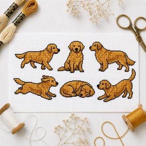 May include: A white fabric piece featuring six cross-stitch golden retriever dogs in various poses, including standing, sitting, running, and sleeping. The dogs are rendered in shades of golden yellow and brown thread on a grid pattern.
