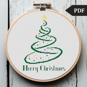 May include: Cross stitch pattern featuring a green spiral Christmas tree with colorful ornaments and the text "Merry Christmas".