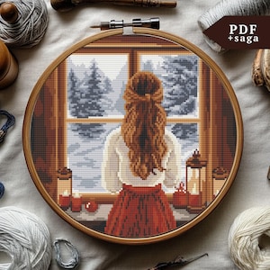 May include: Cross stitch pattern of a woman looking out a window at a snowy winter scene. The woman is wearing a white shirt and a red skirt. There are candles and apples on the windowsill.