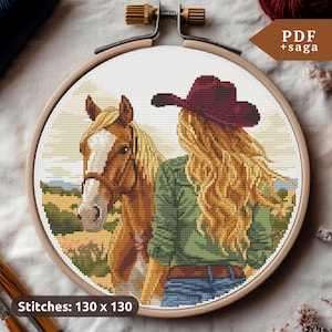 May include: Cross stitch pattern of a woman with long blonde hair wearing a red cowboy hat and a green shirt, standing next to a brown and white horse. The pattern is 130 x 130 stitches.