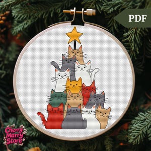May include: A cross-stitch pattern of a Christmas tree made of cats. The cats are stacked on top of each other in a pyramid shape, with a star on top. The cats are all different colors, including white, black, gray, orange, red, and green.