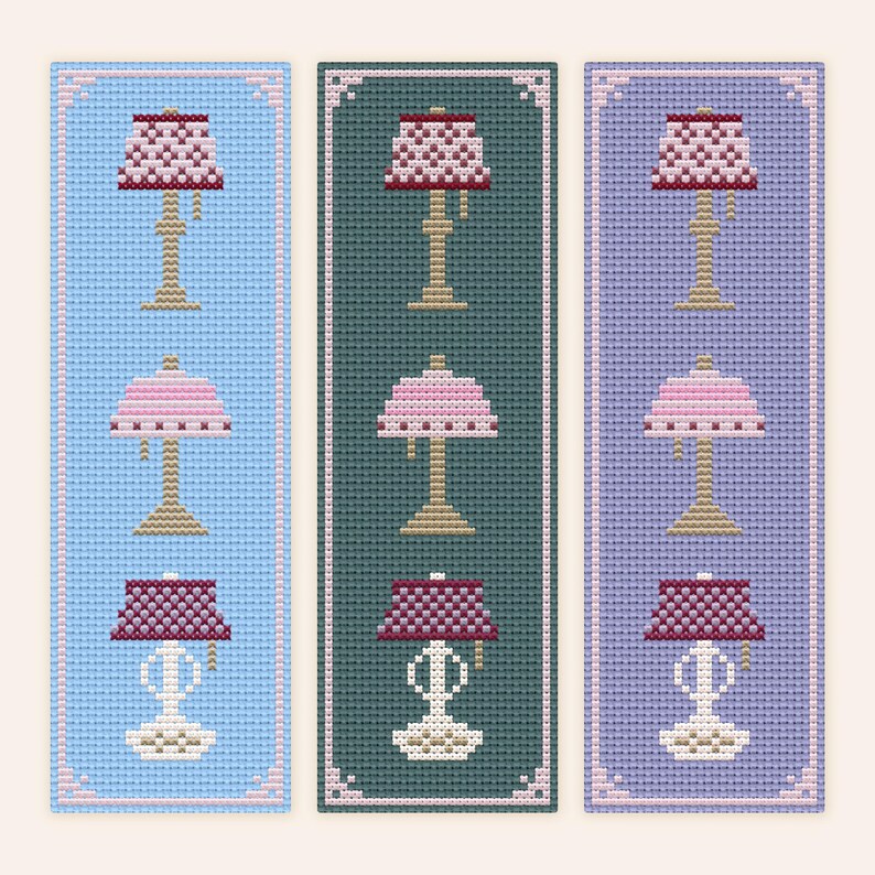 Fancy Lamps cross stitch bookmark pattern features two unique antique inspired lamps in appealing shades of pink, white, and burgundy patinaed brass accents. Examples shown on three different fabric colors: Light Blue, Dark Teal, and Lilac.