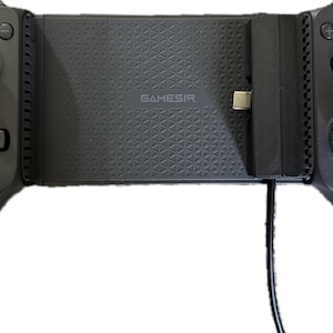 May include: Black GameSir mobile gaming controller with a textured center section and a USB-C connector. The controller has a D-pad, analog sticks, and action buttons. The GameSir logo is visible on the center section. A blue light illuminates the power button.