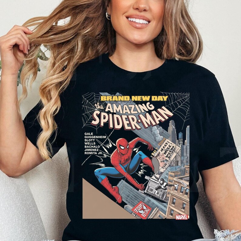 May include: Black t-shirt featuring a comic book cover of Spider-Man. The graphic includes the text "BRAND NEW DAY" and "the AMAZING SPIDER-MAN". The superhero is depicted in a dynamic pose, with a cityscape backdrop and the Marvel logo.