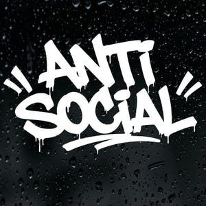 May include: A white vinyl decal featuring the text ANTI SOCIAL in a stylised graffiti font with a dripping paint effect. The design is displayed against a dark, black background covered in numerous small, clear water droplets.