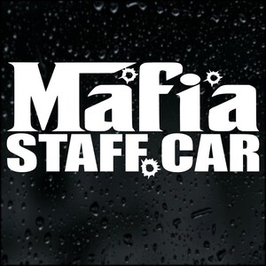 May include: A white graphic on a black background displays the words "Mafia STAFF CAR." Bullet hole designs are incorporated around the word "Mafia." The image has a glossy, wet look, with water droplets.