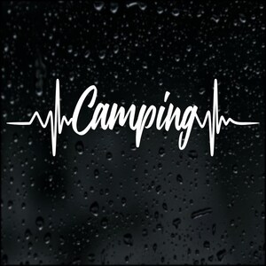 May include: White graphic of the word "Camping" in a heartbeat-style design. The design is on a black background with water droplets.
