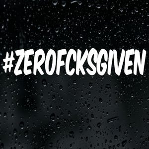 May include: A white vinyl decal sticker featuring the text #ZEROFOCKSGIVEN in a bold, hand-lettered font style. The sticker is applied to a dark, black surface covered in numerous clear water droplets, creating a high-contrast visual effect.