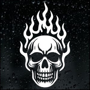 May include: A white skull design with flames rising from the top. The skull features detailed eye sockets, a nasal cavity, and teeth. The flames are stylized, creating a dynamic visual. Ideal for stickers, decals, or clothing.