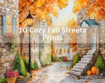 May include: Watercolor painting of a cozy fall street scene. The image features stone buildings, a winding road, and vibrant orange and yellow autumn foliage. The text "10 Cozy Fall Streets Prints" is overlaid on the image.