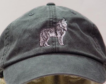 May include: A charcoal gray baseball cap featuring an embroidered design of a wolf standing in profile. The cap has a curved brim, a structured front panel, and stitched eyelets on the crown, showcasing a detailed white and gray thread wolf graphic.