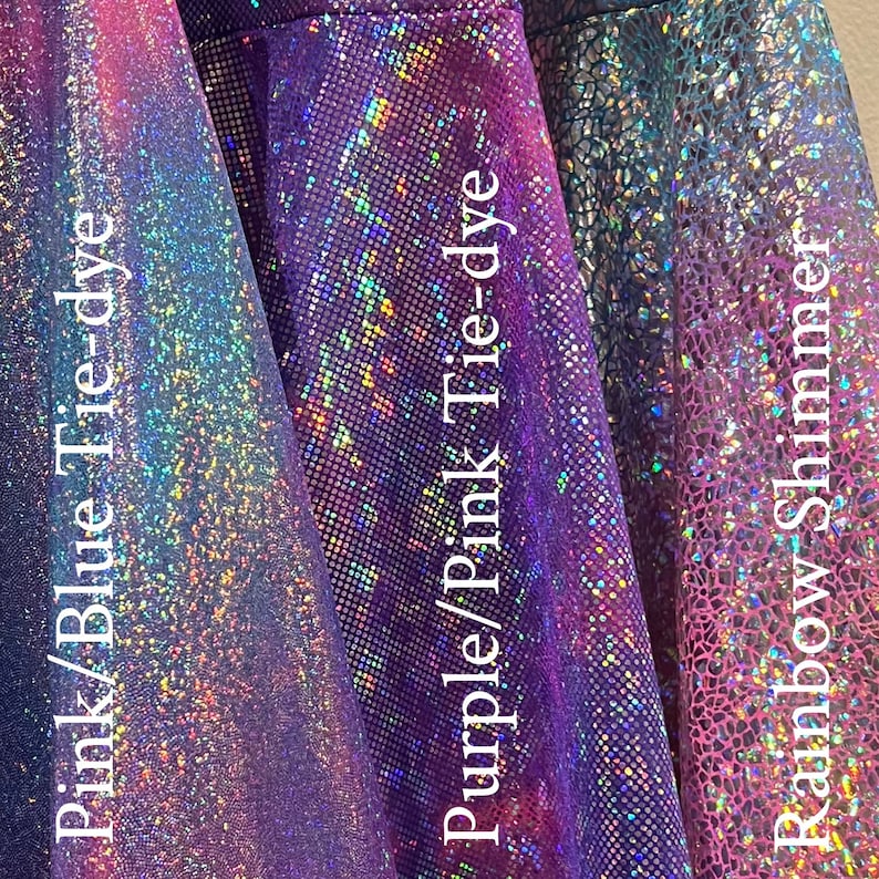 May include: Three swatches of iridescent fabric in pink/blue tie-dye, purple/pink tie-dye, and rainbow shimmer.