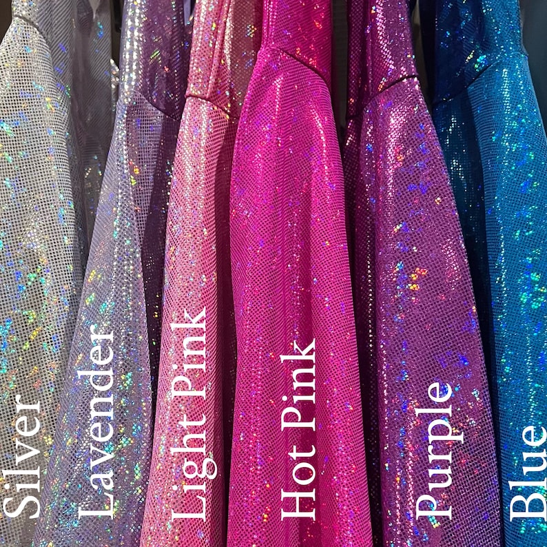 May include: A close-up of six different colours of iridescent fabric. The colours are silver, lavender, light pink, hot pink, purple, and blue.