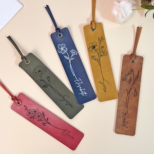 May include: Five leather bookmarks with floral designs and personalized names. The bookmarks are in shades of brown, green, red, and blue. The names on the bookmarks are Olivia, Susan, Sarah, Elizabeth, and Rachel.
