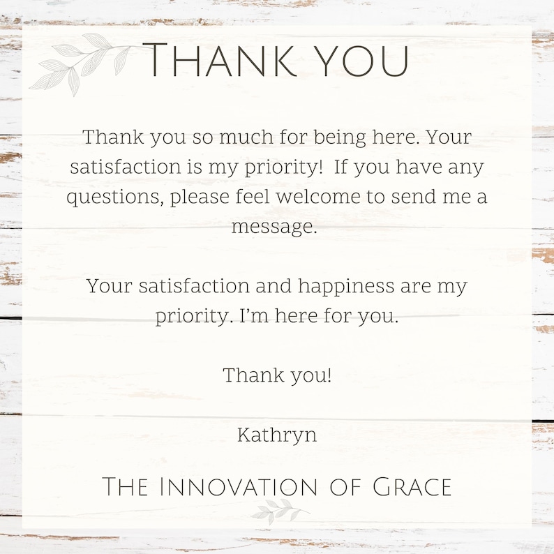 May include: A white card with the words "THANK YOU" at the top, followed by a message of gratitude. The text is in a simple, elegant font. The card is on a white wooden background.