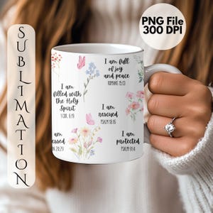 May include: White ceramic mug with floral and butterfly illustrations and inspirational text. The mug features phrases like "I am full of joy and peace" and "I am rescued". The mug is held by a person.