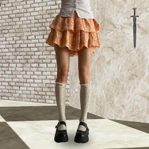 Apricot Ruffled Voluminous Rara Mini Skirt with subtle pink and green floral pattern