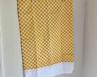 May include: A yellow and white gingham shower curtain with a white border. The curtain is hanging on a wooden hanger.