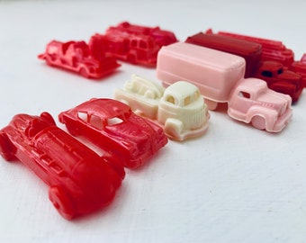 Antique red celluloid cars and trucks