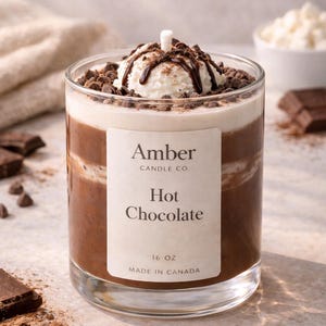 Hot chocolate candle in a clear glass jar designed to look like a warm cup of cocoa, topped with realistic whipped cream wax and chocolate drizzle, handmade soy candle from Amber Candle Co.