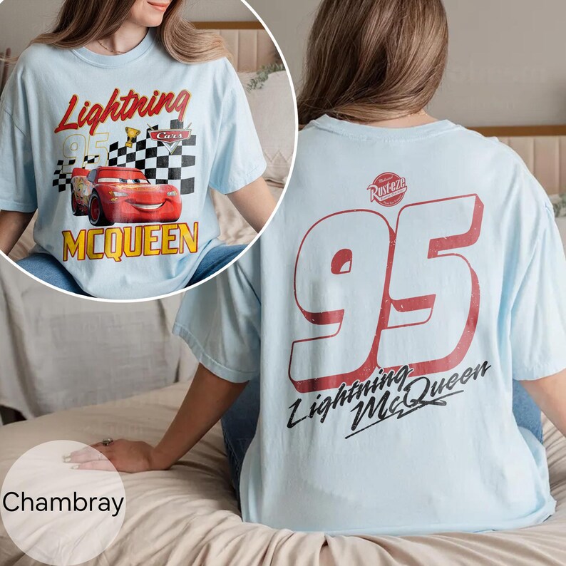 May include: Light blue t-shirt featuring Lightning McQueen from the Cars movie. The front graphic includes McQueen, the number 95, and a checkered flag. The back of the shirt displays a large red number 95 and the text "Lightning McQueen".