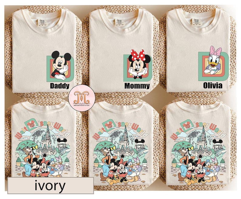 May include: Ivory t-shirts with Disney character designs. One shirt features Mickey Mouse with "Daddy", another has Minnie Mouse with "Mommy", and a third has Daisy Duck with "Olivia". The bottom shirts have a Disney World graphic.