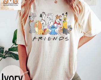 May include: Ivory t-shirt with a graphic of various cartoon dogs and the word "FRIENDS" printed on the front.