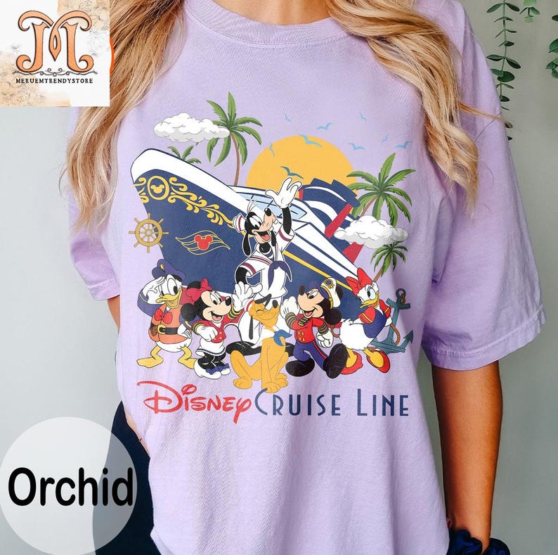 May include: Orchid-colored t-shirt featuring a Disney Cruise Line design. The graphic includes Mickey Mouse, Minnie Mouse, Donald Duck, and other characters with a cruise ship, palm trees, and a sunset. The text "Disney Cruise Line" is printed below the characters.