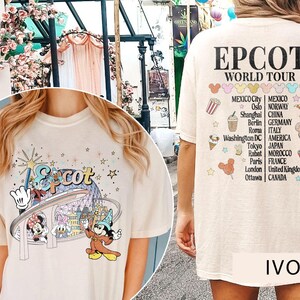 May include: A light beige t-shirt featuring a graphic of Mickey Mouse and friends at Epcot. The back of the shirt displays the text "EPCOT WORLD TOUR" and a list of countries and cities.