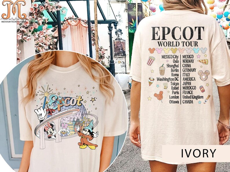 May include: A light beige t-shirt featuring a graphic of Mickey Mouse and friends at Epcot. The back of the shirt displays the text "EPCOT WORLD TOUR" and a list of countries and cities.