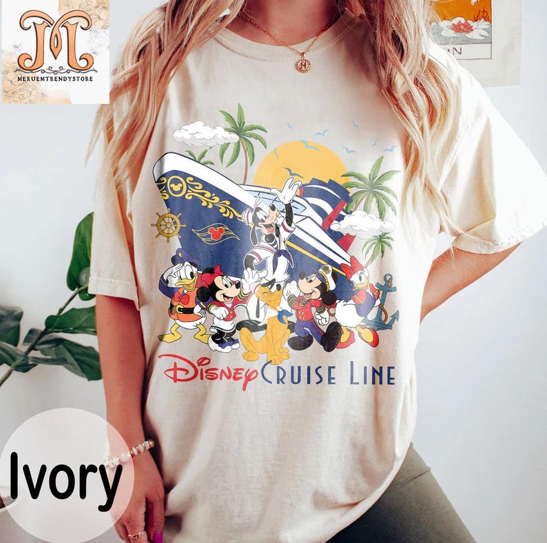 May include: Ivory-colored t-shirt featuring a Disney Cruise Line design. The graphic includes Mickey Mouse, Minnie Mouse, Donald Duck, and other characters on a cruise ship with palm trees and a sunset. The text "Disney Cruise Line" is printed below the characters.