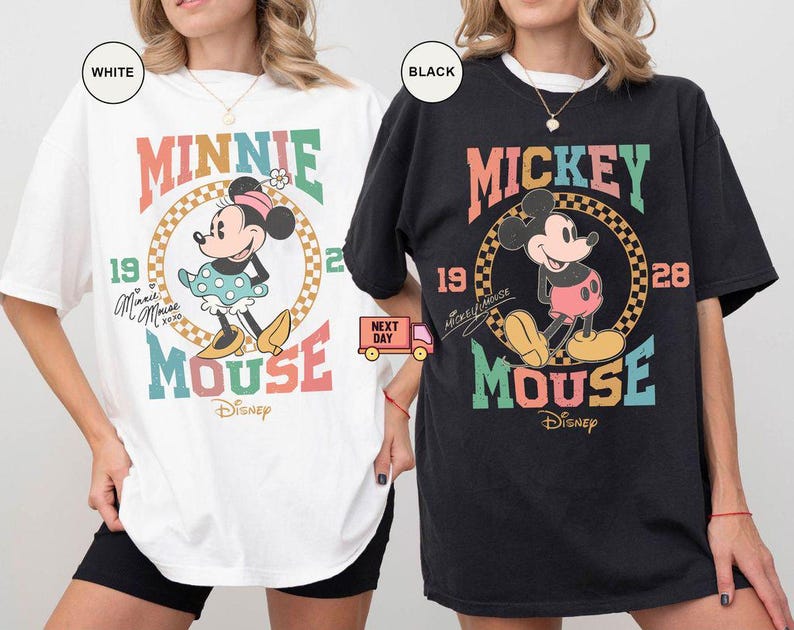 May include: Two oversized t-shirts featuring vintage-style graphics of Mickey and Minnie Mouse. The Mickey Mouse shirt is black with a colorful graphic that says "Mickey Mouse" and "19 28". The Minnie Mouse shirt is white with a colorful graphic that says "Minnie Mouse" and "19 28".