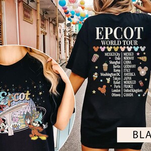 May include: Black t-shirt featuring a graphic of Mickey Mouse and friends at Epcot's World Showcase. The back of the shirt lists the countries represented at Epcot, including Mexico, Norway, China, Germany, Italy, America, Morocco, France, the United Kingdom, and Canada.