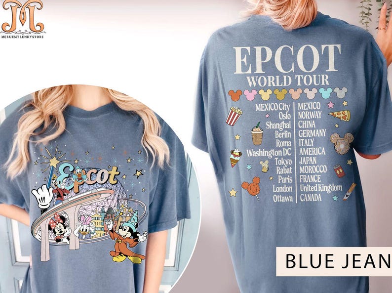 May include: Blue jean t-shirt featuring a graphic of Mickey Mouse and friends on a ride at Epcot. The back of the shirt displays the text "Epcot World Tour" and a list of countries and cities.