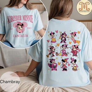 May include: A light blue t-shirt with the text "Sorcerer Minnie Est. 1940 Fantasia" on the front and a pattern of Minnie Mouse dressed as a sorceress on the back.