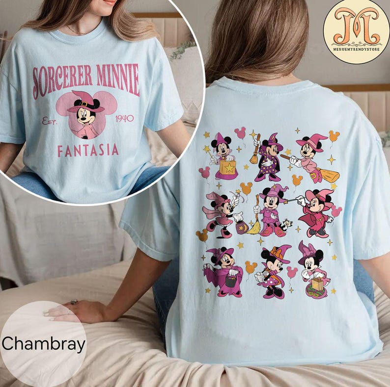 May include: A light blue t-shirt with the text "Sorcerer Minnie Est. 1940 Fantasia" on the front and a pattern of Minnie Mouse dressed as a sorceress on the back.