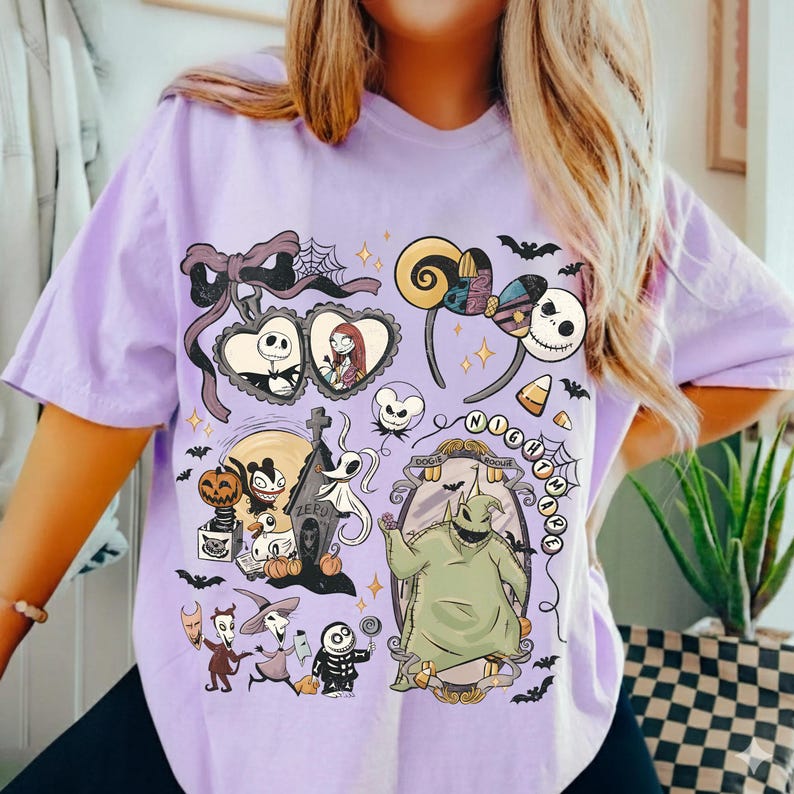 May include: A light purple t-shirt featuring a graphic print of characters from The Nightmare Before Christmas, including Jack Skellington, Sally, Oogie Boogie, and Zero, surrounded by bats, pumpkins, and a decorative mirror frame.