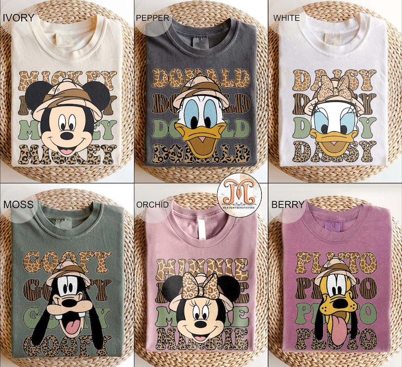 May include: Ten different color t-shirts with a Disney character graphic and text. The shirts feature Mickey Mouse, Donald Duck, Daisy Duck, Goofy, and Minnie Mouse. The text on the shirts includes "Mickey", "Donald", "Daisy", "Goofy", and "Minnie".