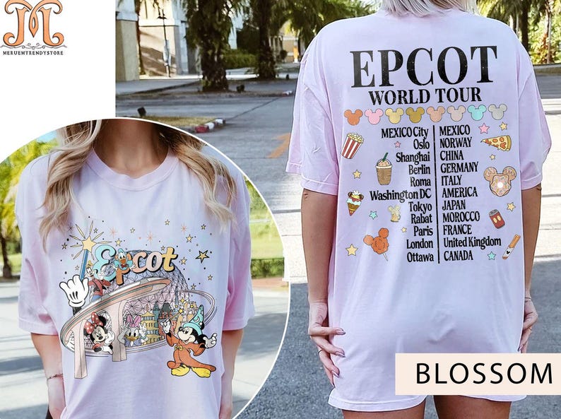 May include: Pink t-shirt featuring a graphic of Mickey Mouse and other Disney characters at Epcot. The back of the shirt displays the text "Epcot World Tour" and a list of countries and cities.